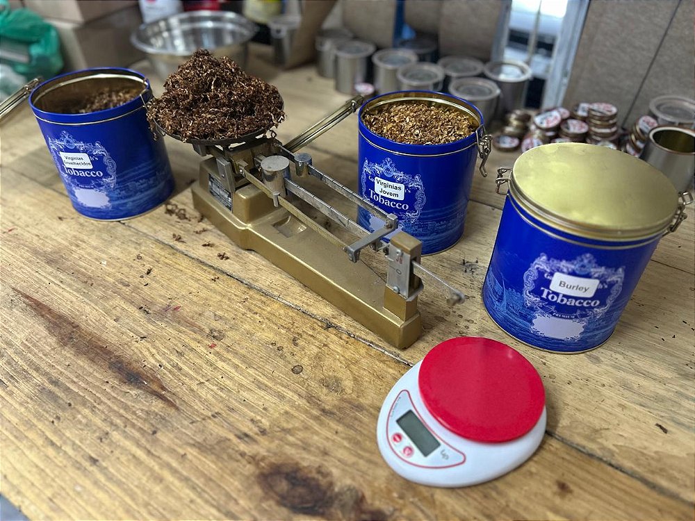 A bancada de trabalho do artesão com balança de precisão e tabacos.