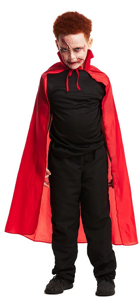 Menino vampiro de halloween acena sua capa preta e vermelha com as mãos  rodeadas sobre o fundo vermelho do estúdio. maquiagem de vampiro de  criança.
