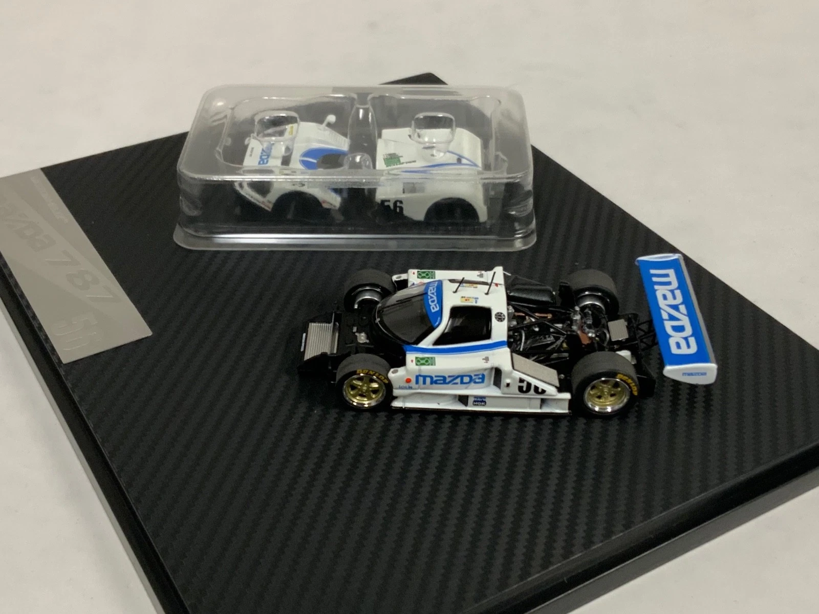 まち Mazda 787 Cibié 1:64 MOTORHELIX HEC 2026 - 20 anos! Loja on-line