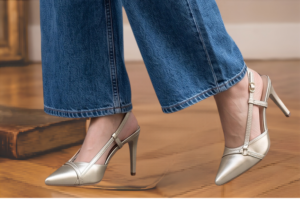 Sapato scarpin feminino modelo slingback de bico fino na cor napa Dourado-Champagne Torricella  com fivela dourada, exposto sobre uma mesa de vidro em uma galeria de arte moderna luxuosa.