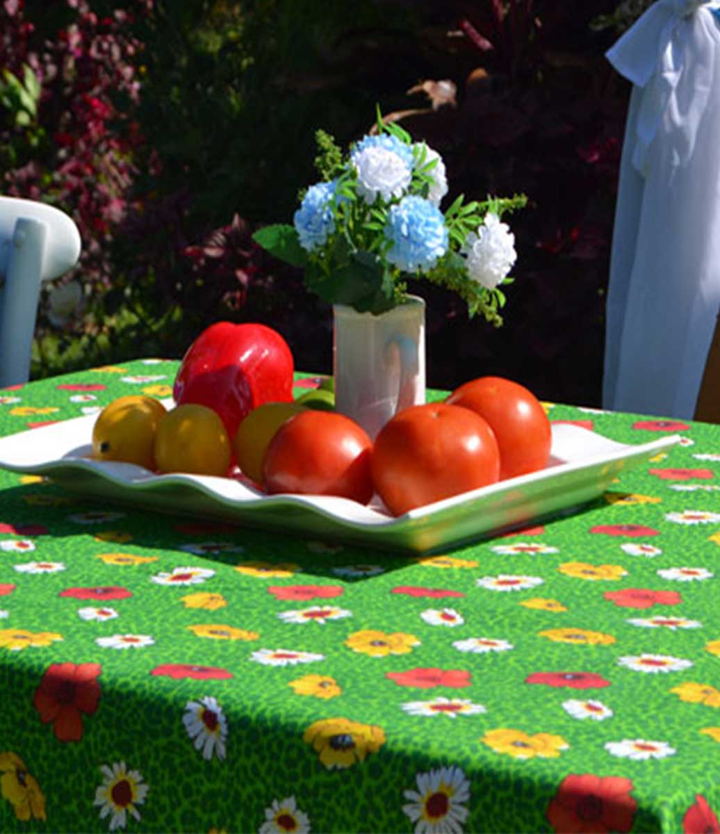 Jardim com Mesa Decorada com Centro de Mesa com Frutas e Toalha de Mesa Verde com Estampa de Flores