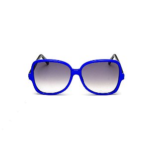 Óculos de Sol Gustavo Eyewear G110 13. Cor: Azul translúcido. Haste preta. Lentes cinza.