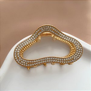 PRESILHA UNITÁRIA FORMATO ABSTRATO STRASS DOURADO BIJU