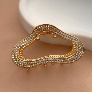 PRESILHA UNITÁRIA FORMATO ABSTRATO STRASS DOURADO BIJU