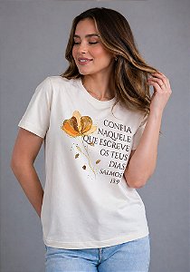 T-SHIRT FEMININA - CONFIA NAQUELE QUE ESCREVE OS TEUS DIAS - COR MARFIM