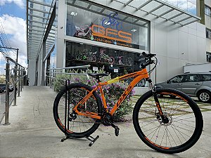 BICICLETA MTB ARO (29) OXS ALUMINIO 21 VELOCIDADES FREIO DISC MECÂNICO 19 (G) LARANJA/VINHO
