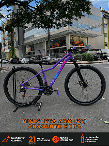 BICICLETA MTB ARO (29) ABSOLUTE HERA 21 VELOCIDADES FREIO A DISCO MECÂNICO TAMANHO 15 (P) COR ROXO/ROSA/AZUL