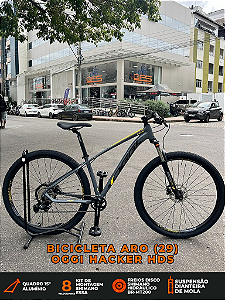 BICICLETA MTB ARO (29) OGGI HACKER HDS SHIMANO ESSA 8V FREIO DISC HIDRÁULICO TAMANHO 15 (P) COR GRAF/AMAR/PTO