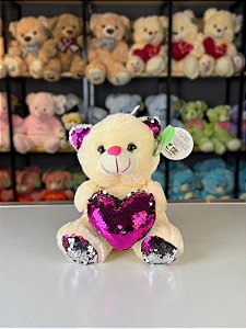 Urso pelúcia com coração lantejoulas cores -20cm und.