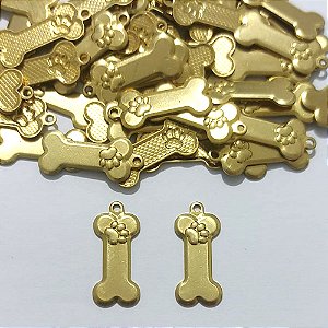 ACESSÓRIO NO BRUTO PRONTO PARA O BANHO - (4573) PLAQUINHA OSSO COM PATINHA 18MM - PESO 0,8GR - COMPOSIÇÃO 100% LATÃO - BRU27140