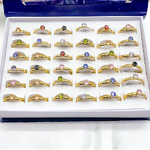 CAIXA ANEL AÇO INOXIDÁVEL TIPO SOLITÁRIO DOURADO 36 PEÇAS - PEDRAS COLORIDAS