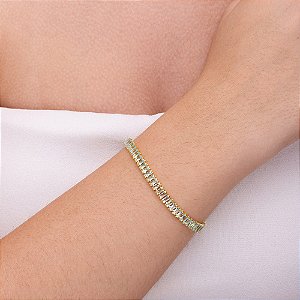 Pulseira rivieira em baguete com zircônia azul claro folheada a ouro
