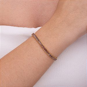 Pulseira rivieira em baguete com zircônia lilás folheada a ouro