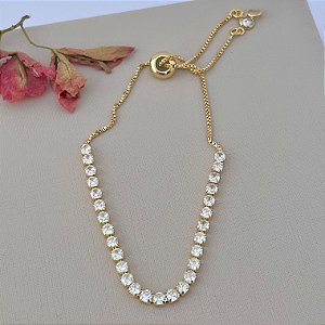 Pulseira riviera com fecho gravata em banho de ouro 18k