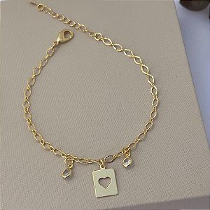 Pulseira placa com coração vazado e pontos de luz em banho de ouro 18k