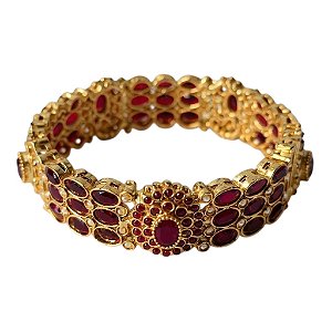 Bracelete dourado com pedras vermelhas.
