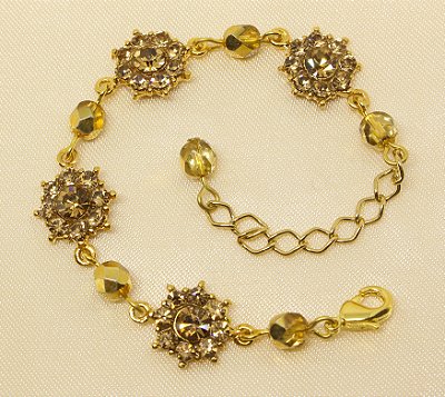 Pulseira flor de strass base ouro