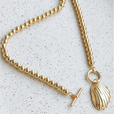 Colar Dourado com Pingente de Concha e Fecho T – Beleza Marinha 2026