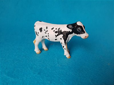 Miniatura de vinil Schleich de bezerro Holstein, de 2007, 8cm.comprimento