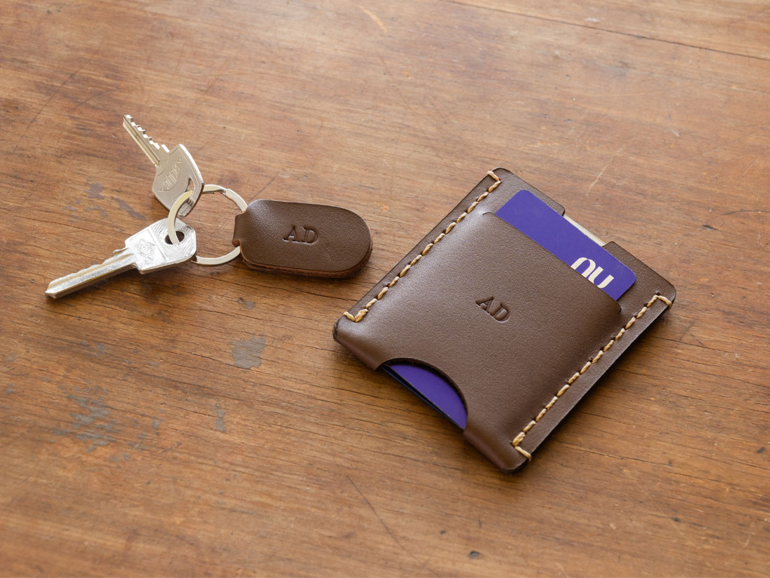 O porta-cartões pode ser personalizado com a gravação em baixo relevo das iniciais do seu nome na face frontal, além de em um chaveiro exclusivo que o acompanha. O porta-cartões pode ser personalizado com a gravação em baixo relevo das iniciais do seu nome na face frontal, além de em um chaveiro exclusivo que o acompanha.