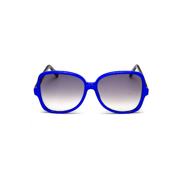 Óculos de Sol Gustavo Eyewear G110 6. Cor: Azul translúcido. Haste preta. Lentes cinza.