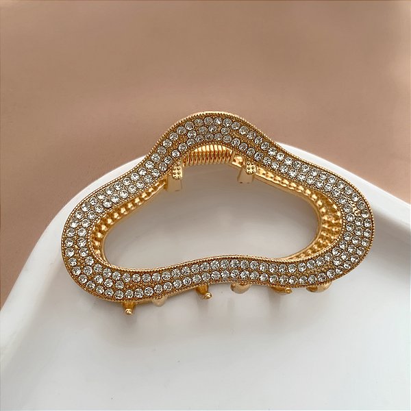 PRESILHA UNITÁRIA FORMATO ABSTRATO STRASS DOURADO BIJU