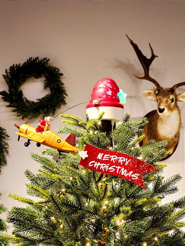 PONTEIRA PARA ÁRVORE COM AVIÃO DO PAPAI NOEL COM MOVIMENTO, LUZ E SOM