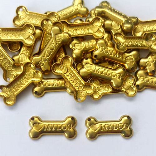 ACESSÓRIO NO BRUTO PRONTO PARA O BANHO - (2558) OSSO MY DOG 18MM COM DOIS FUROS - PESO TOTAL 0,8GR - COMPOSIÇÃO: 100% LATÃO - BRU0003403