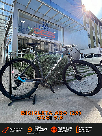 BICICLETA MTB ARO (29) OGGI BW 7.0 SHIMANO CUES 9 VELOCIDADES FREIO DISC HIDRÁULICO TAMANHO 21 (GG) GRAFITE/AZUL/CINZA