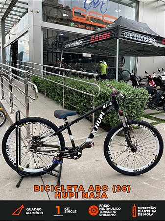BICICLETA MTB FREERIDE ARO (26) HUPI NAJA KIT SINGLE S/ MARCHA FREIO DISC HIDRÁULICO TRASEIRO SHIMANO COR PRETO/BRANCO