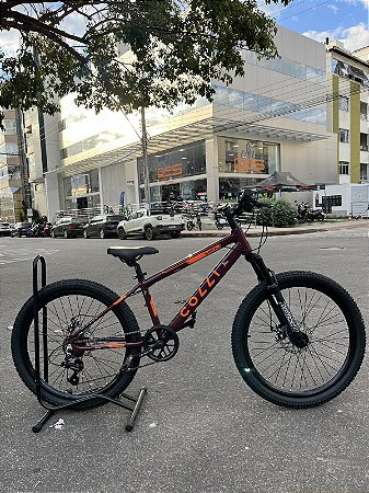 BICICLETA ARO (24) MTB COLLI NAPOLI ALUMINIO 7 VELOCIDADES (1X7) FREIO A DISCO MECÂNICO COR VINHO/LARANJA