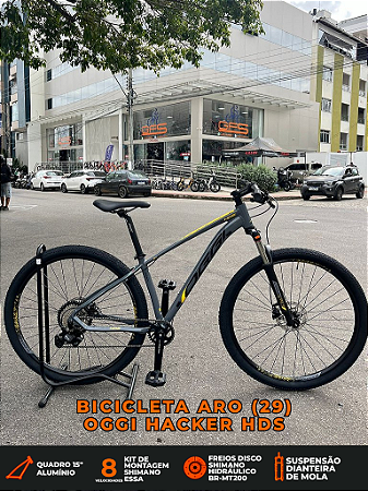 BICICLETA MTB ARO (29) OGGI HACKER HDS SHIMANO ESSA 8V FREIO DISC HIDRÁULICO TAMANHO 15 (P) COR GRAF/AMAR/PTO