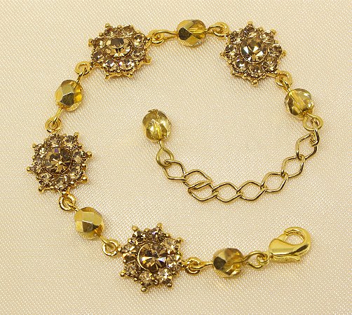 Pulseira flor de strass base ouro