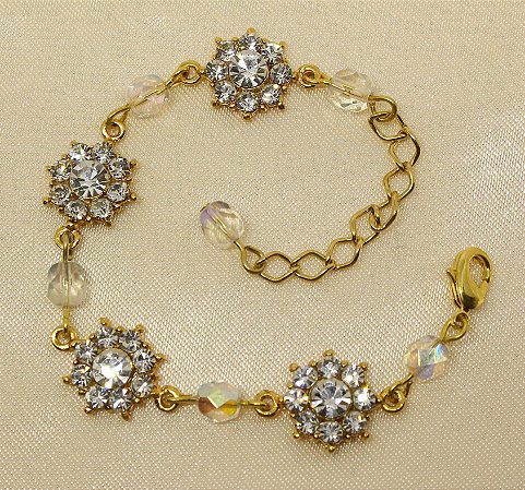 Tornozeleira flor de strass base ouro