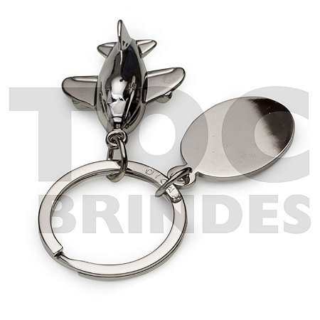 Chaveiro em aço brilhante, formato de avião, “3D”, com chapinha para personalização e argola alto brilho