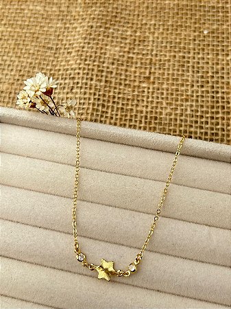 PULSEIRA ESTRELA ENTRE PONTOS DE LUZ BANHADA A OURO