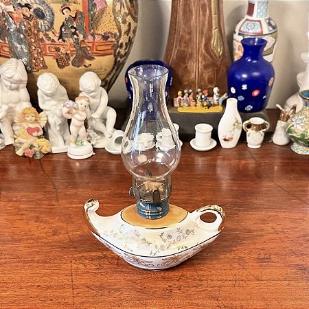 Antiga lamparina palmatória em porcelana.