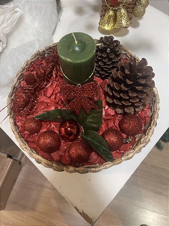 Arranjo com folhagem vermelha e vela verde