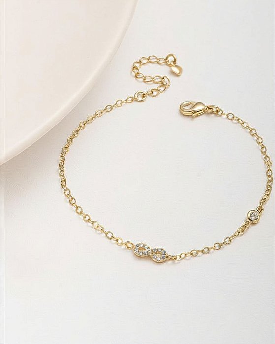 Pulseira delicada pingente infinito cravejado de zircônias folheado a ouro 18K hipoalergênico