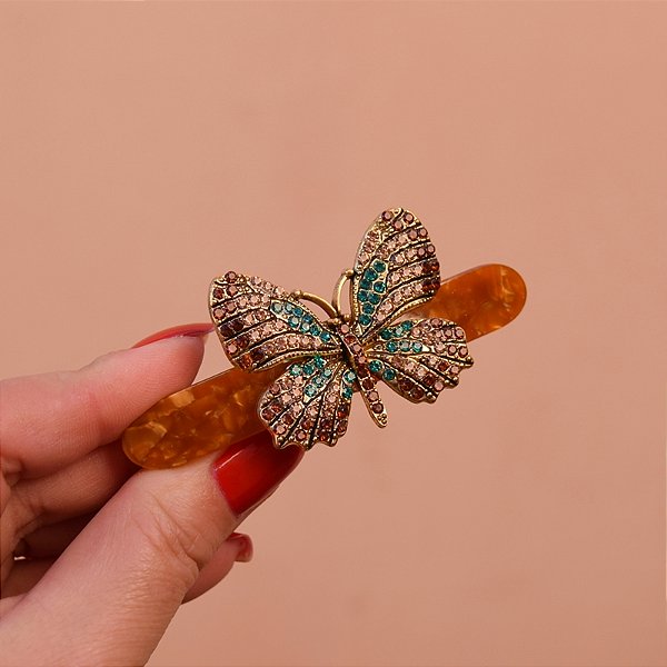 Presilha acrílico marmorizado caramelo borboleta cristais coloridos