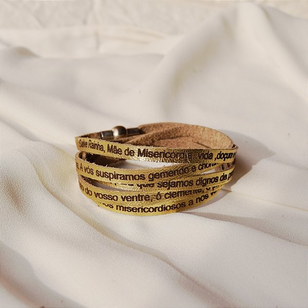 Pulseira Fernanda Villela couro dourado oração Salve Rainha