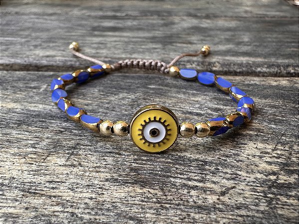 Pulseira Cristais Facetados Azul com Olho Grego Amarelo
