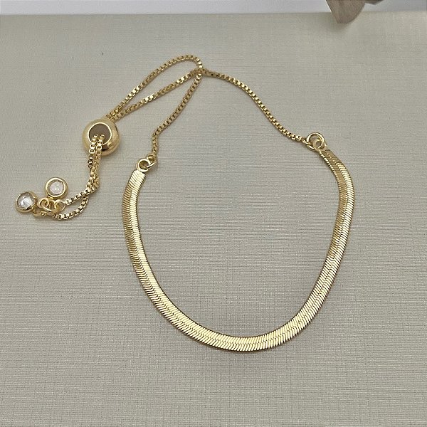 Pulseira fita com fecho gravata em banho de ouro 18k