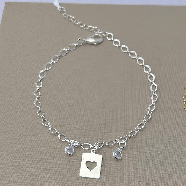 Pulseira placa com coração vazado e pontos de luz em banho de prata silver
