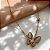 COLAR BORBOLETA PEDRA OLHO DE GATO DOURADO AÇO 316L⭐️ - Imagem 1