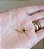 COLAR COM ESTRELA BANHADO A OURO 18 K EM FIO DE NYLON - Imagem 1