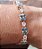 CONJUNTO BRINCO E PULSEIRA COM ZIRCONIAS AZUL E CRISTAL BANHADO A OURO 18 K - Imagem 2