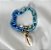 PULSEIRA CORRENTE ESMALTADA AZUL COM BUZIO BANHADA A OURO 18 K - Imagem 2