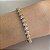 Pulseira riviera em formato de mini corações cravejados com zircônias na cor cristal 18cm de comprimento com banho de ouro 18k - Imagem 2