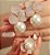 Anel de flor 3 pétalas cravejadas com zircônias cristal e pérola shell com banho de ouro 18k - Imagem 2